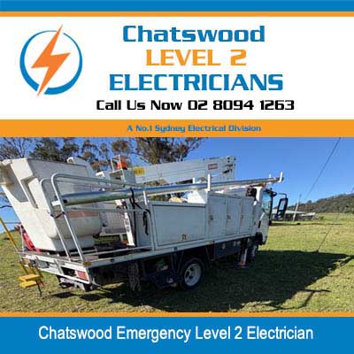Emergency utility truck with elevated platform and electrical equipment parked in open field in Chatswood