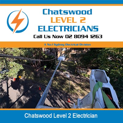 Level 2 electricians working outdoors in residential yard with equipment and ladder in Chatswood