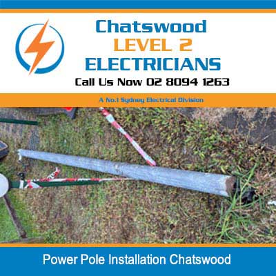 Power pole lying on ground prepared for installation among vegetation in Chatswood